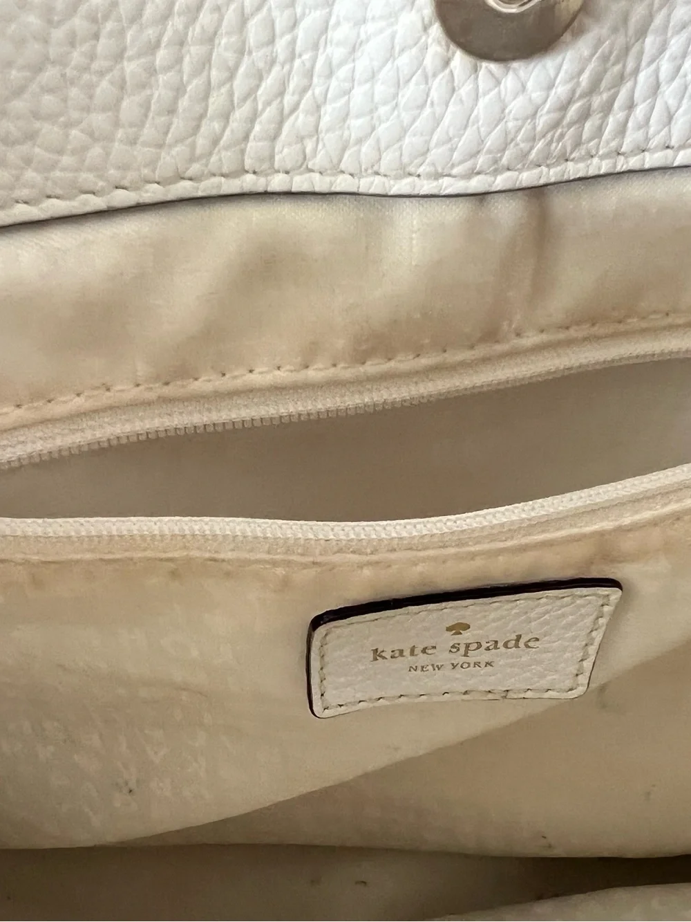 Kate Spade New York creamy white leather drawstring flap backpack